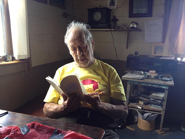 Robert Frank holding copy of The Americans List